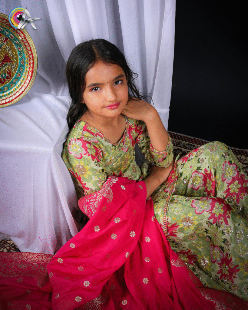 Girl in a traditional floral outfit with a red dupatta posing gracefully