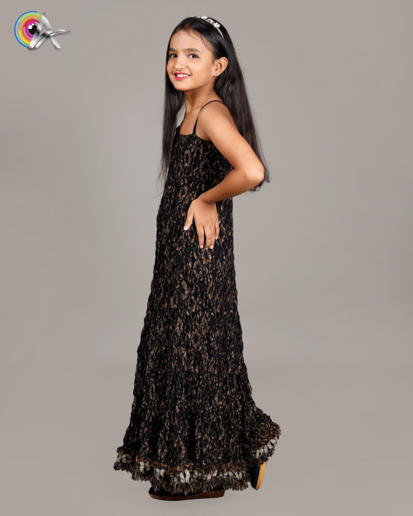 Children’s designer gown featuring a sleeveless design, elegant texture, and detailed hem – ideal for festive and party wear.