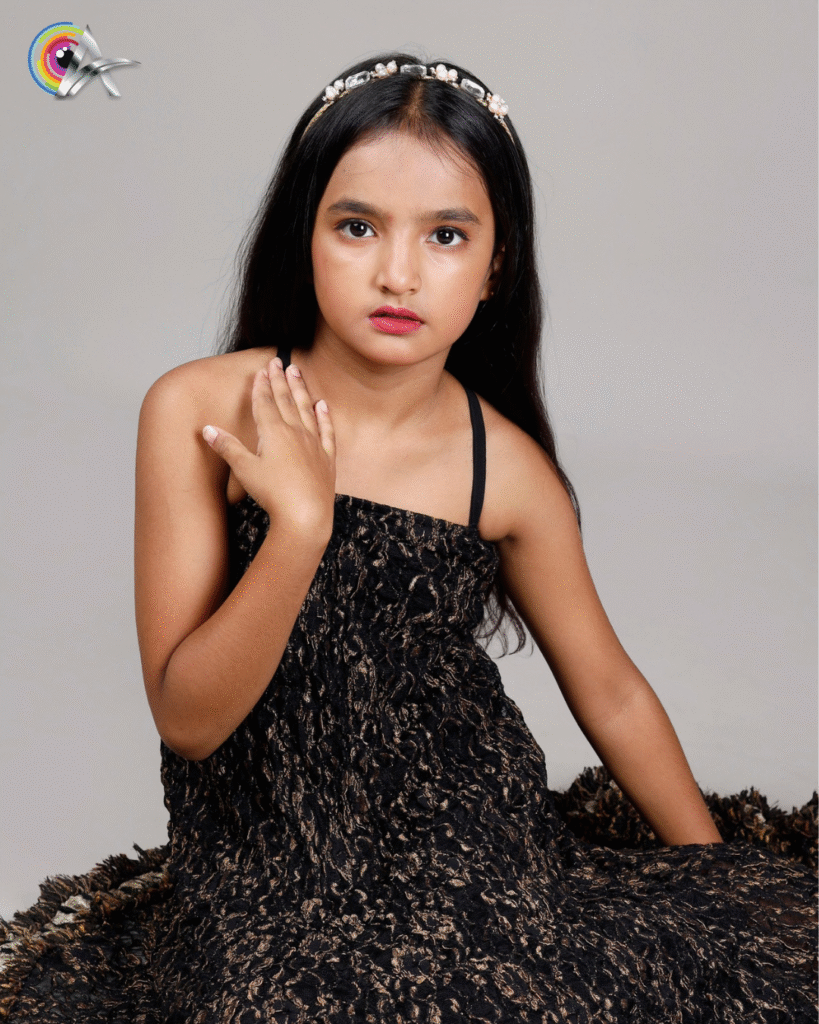 Young girl posing elegantly in a floor-length textured gown, perfect for portfolio and brand shoots.