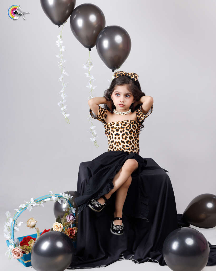 Happy girl posing for birthday-themed modeling shoot